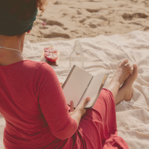 black-woman-sitting-reading-book-practicing-fertility-selfcare